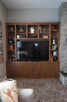 Thumb great room  contemporary style  walnut  medium color  banded door  entertainment  center  wood top  bookcase  built ins  vertical grain  frameless construction