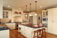 Thumb kitchen  craftsman style  painted  recessed panel  flush mount  glass grid doors  wood hood  butcher block top  turned posts   legs  overhang on the end